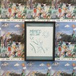 Framed screen printed poster for the Mimico Arts Jam hanging on wall. On the all are wheat pasted event posters