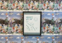 Framed screen printed poster for the Mimico Arts Jam hanging on wall. On the all are wheat pasted event posters